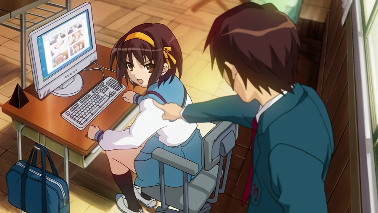 Kyon is shocked as he catches Haruhi uploading photos of Mikuru to the SOS Brigade website